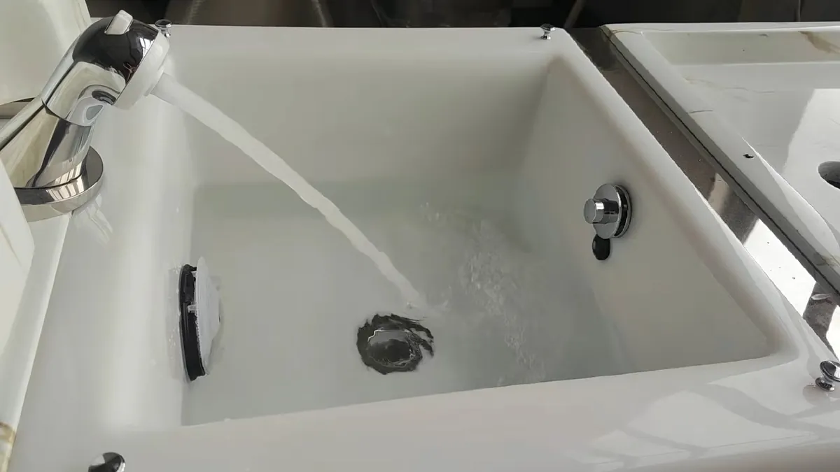 Water running into a pedicure chair basin in the workshop