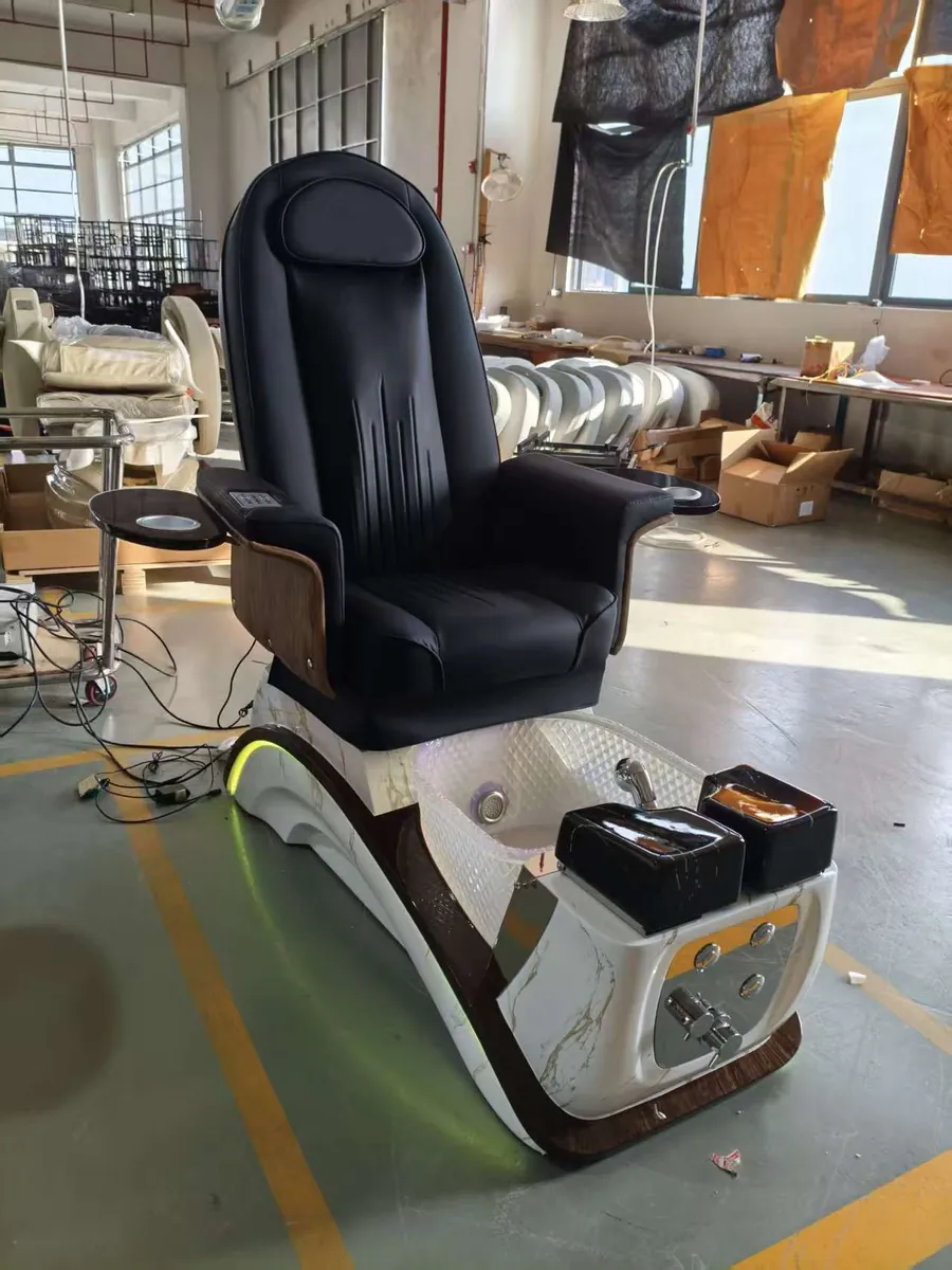 Black-upholstered PC-50 pedicure chair photographed in the workshop